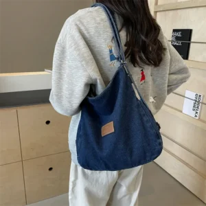 Denim shoulder bag with adjustable strap in dark wash