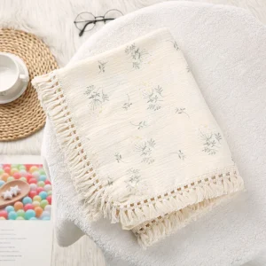 Double layer cotton gauze baby blanket folded flat showing open weave texture