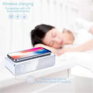 LED digital alarm clock with wireless charging pad on a bedside table