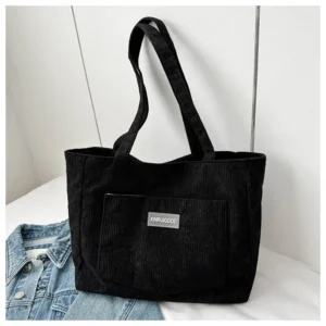 Corduroy crossbody bag shown in a flat lay against a neutral background