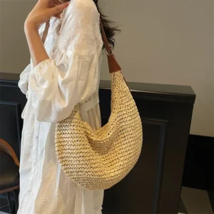 Woven straw shoulder bag shown from the front on a plain background