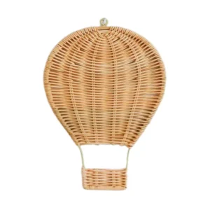 Rattan hot air balloon wall hanging displayed above a crib in a nursery