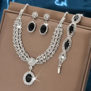 4-piece sapphire-style jewelry set laid out with necklace, earrings, and bracelet