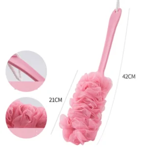 Long handle bath brush leaning against a bathtub edge