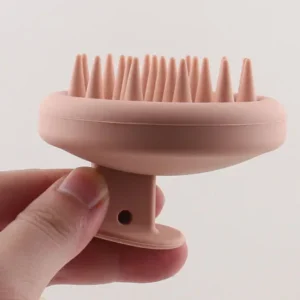 Silicone scalp massage brush held in hand for shower use