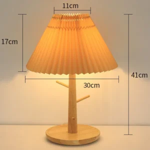 Pleated bamboo bedside lamp glowing softly on a nightstand