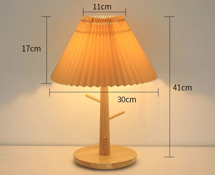 Pleated bamboo bedside lamp glowing softly on a nightstand