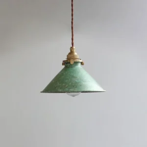 Rustic iron pendant light hanging above a wooden dining table