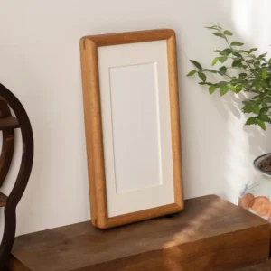 Solid wood photo frame standing upright on a desk